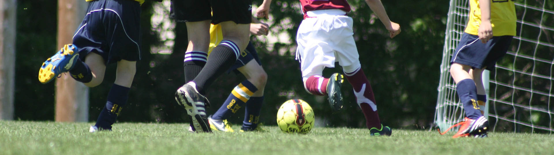 Waist-down photo of players racing for the ball.